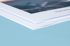 high-quality photo book, soft cover in square format, detail view of the spine